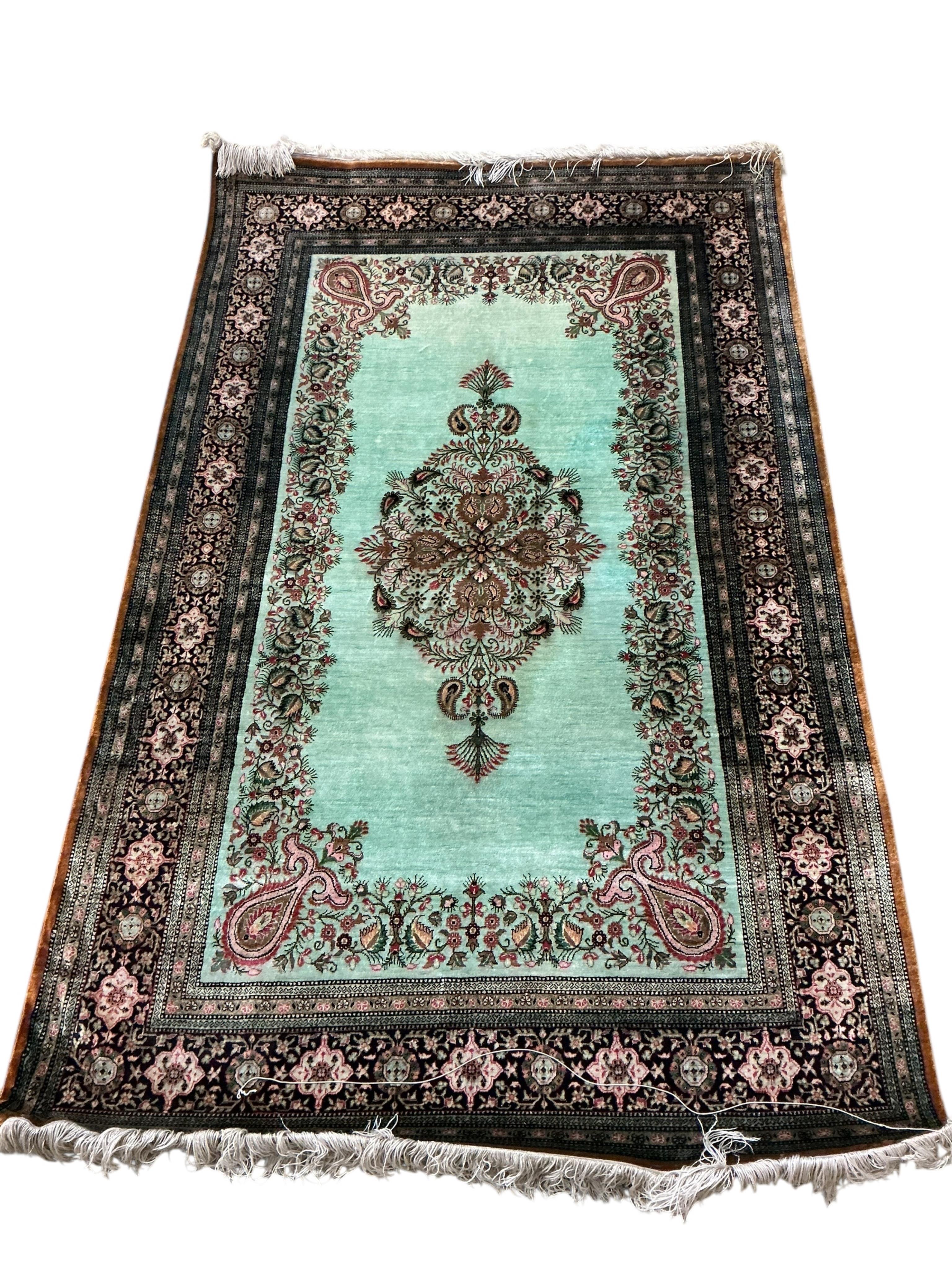 A North West Persian part silk Naeen-Ghom pale green ground rug, 160 x 98cm